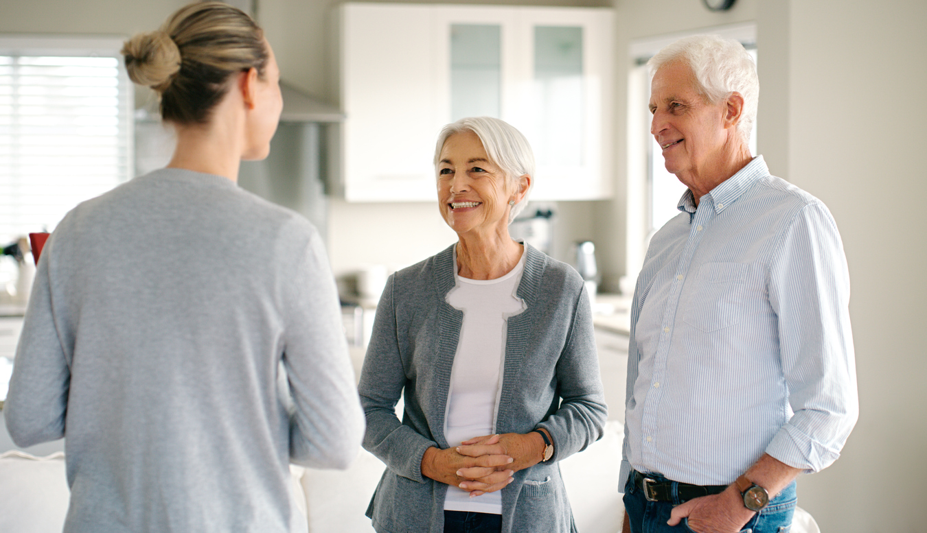 Home, old couple and real estate consultant with mortgage, conversation and retirement. People, elderly man and senior woman with property investor, talking and pension fund with financial adviser